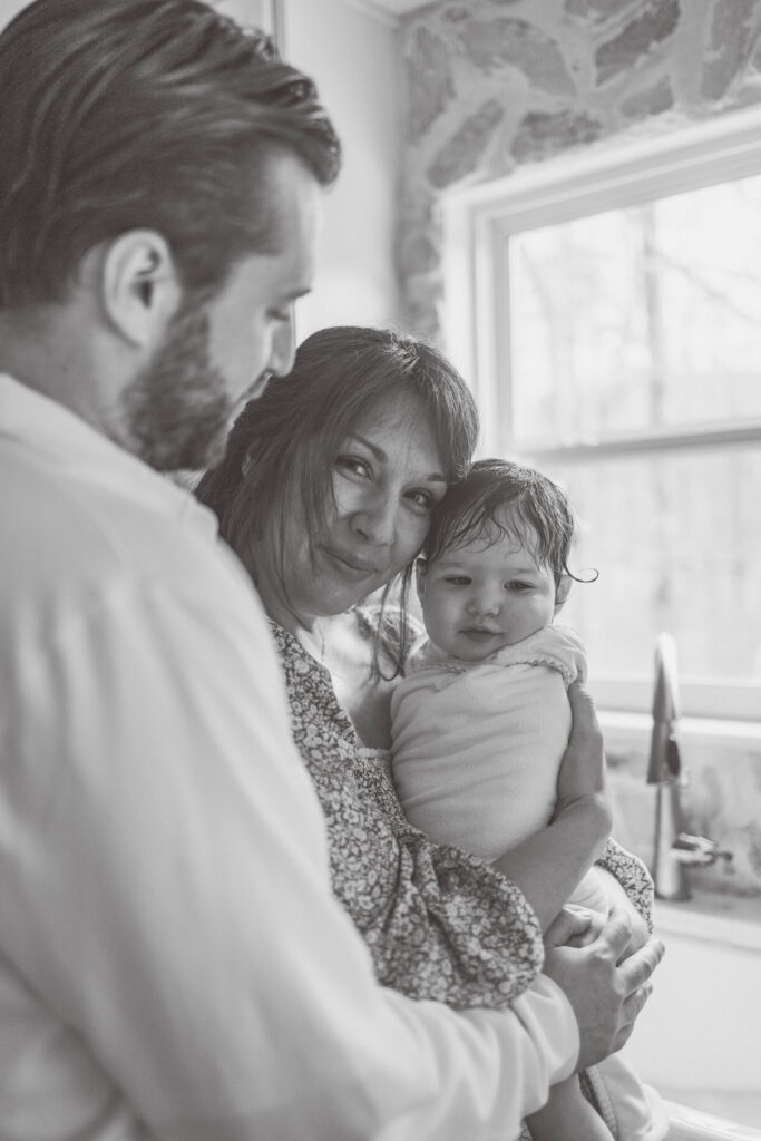 baby wrapped in towel snuggling mom after bath time in Knoxville TN