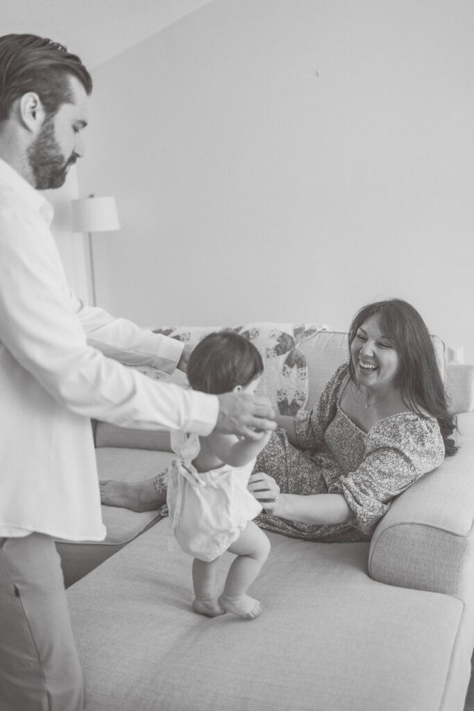 mom cuddling toddler on couch during in home family session in Knoxville. best parks in Knoxville for kids
