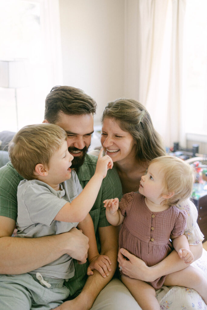 Family cuddling together during a relaxed at-home photo session in Knoxville