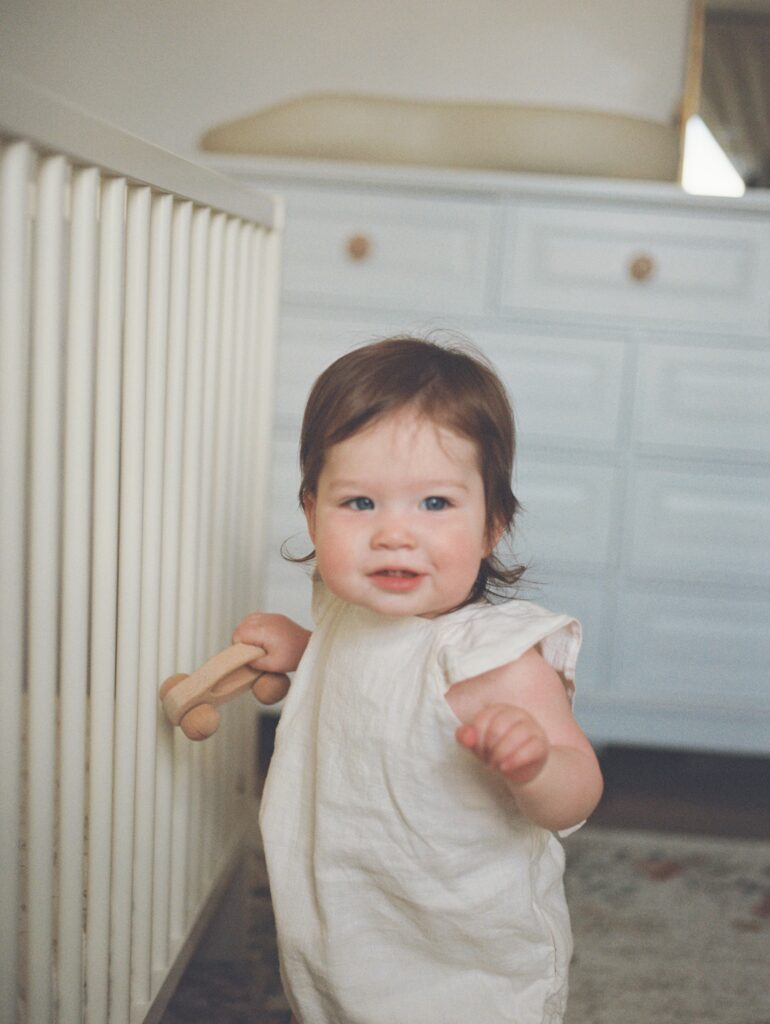 Baby exploring their nursery during a Baby's First Year photography session in Knoxville.