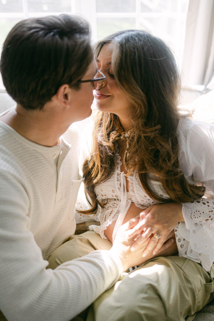 Couple embracing while awaiting their baby's arrival during a lifestyle maternity session in Knoxville.