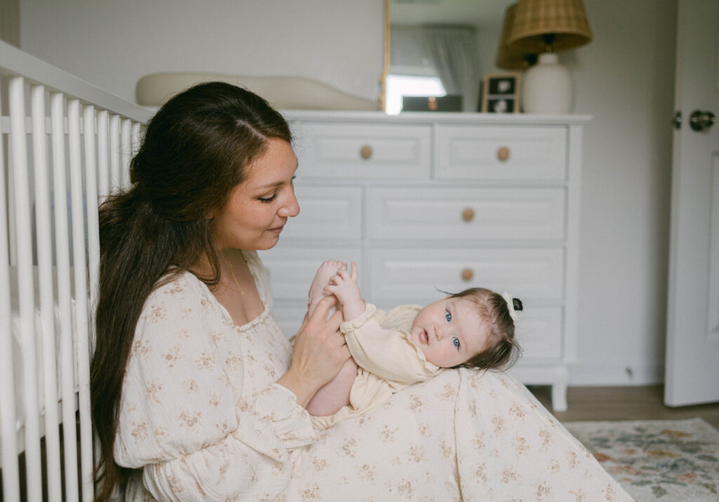 Mom wearing a neutral, flowy dress during an in-home family photography session, showcasing timeless outfit inspiration.